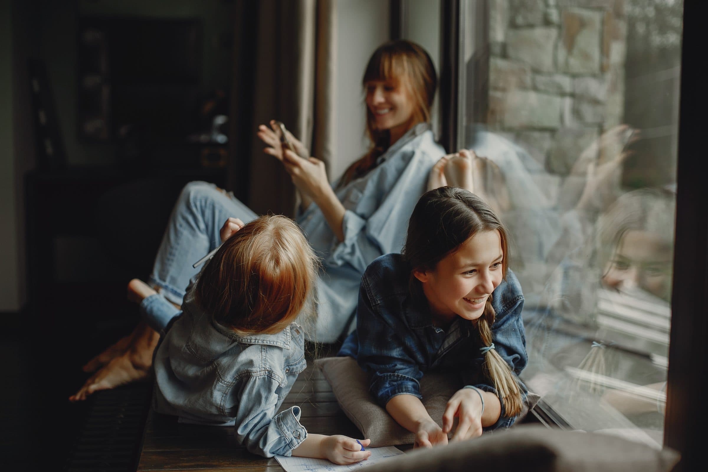 A mother and her two daughters relaxing at home